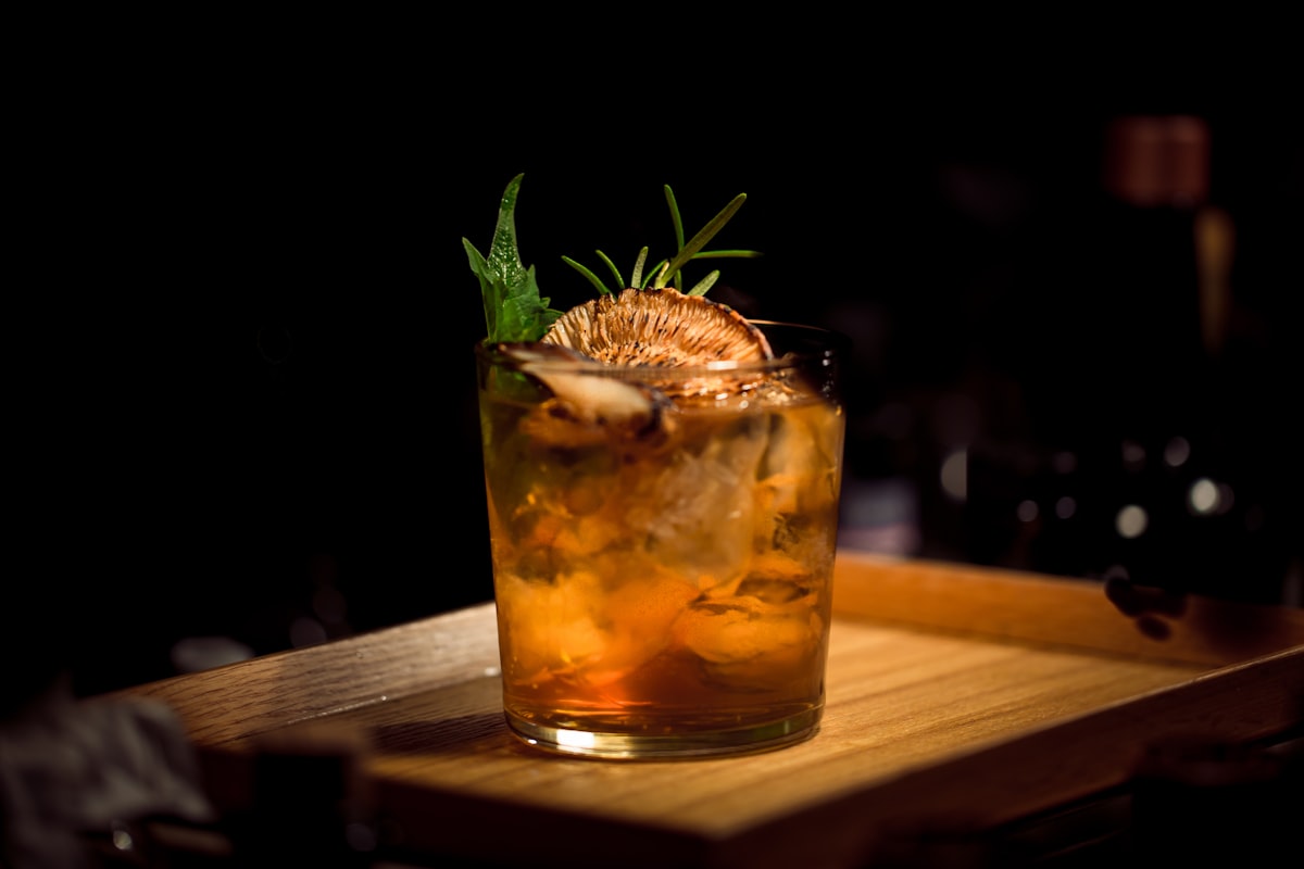 Bartender pouring a cocktail at a dimly lit bar